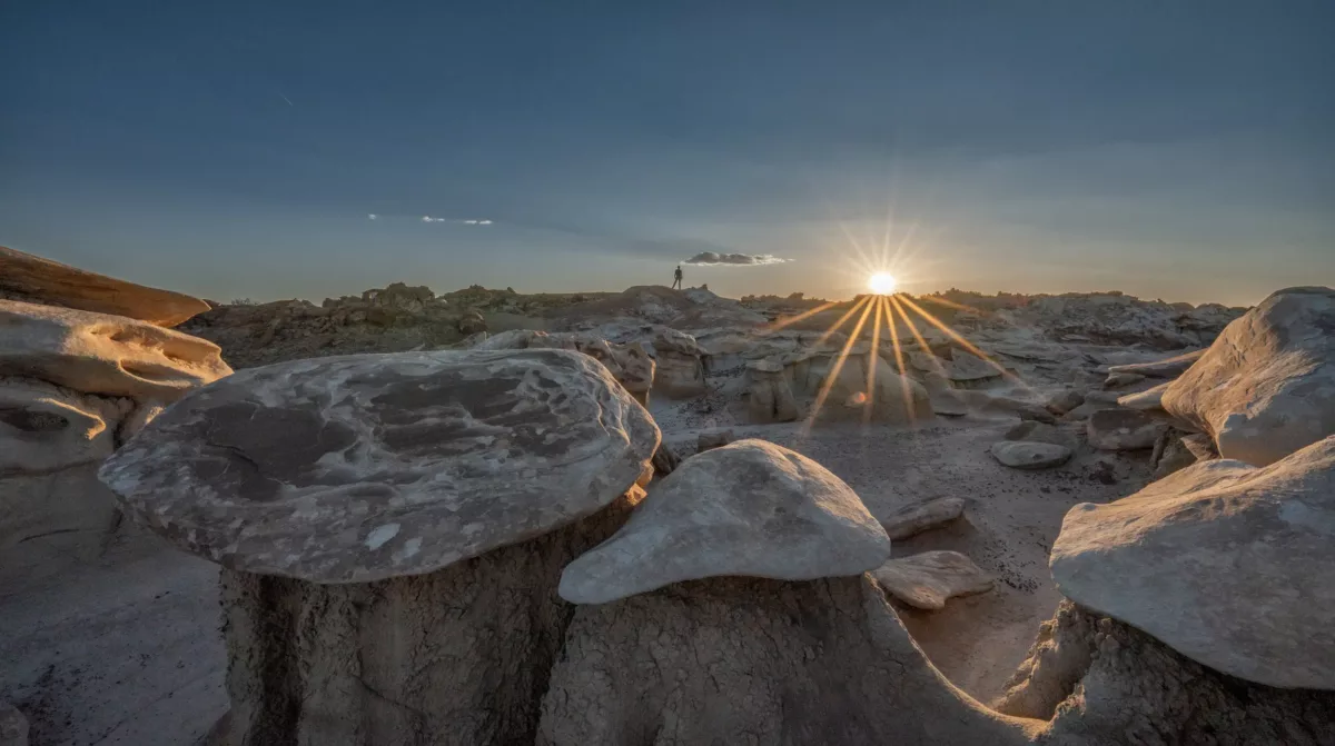 Sunset amongst the hoodoos in the Bisti Badlands of central New Mexico. Friend Brad Goldpaint on the horiozon.